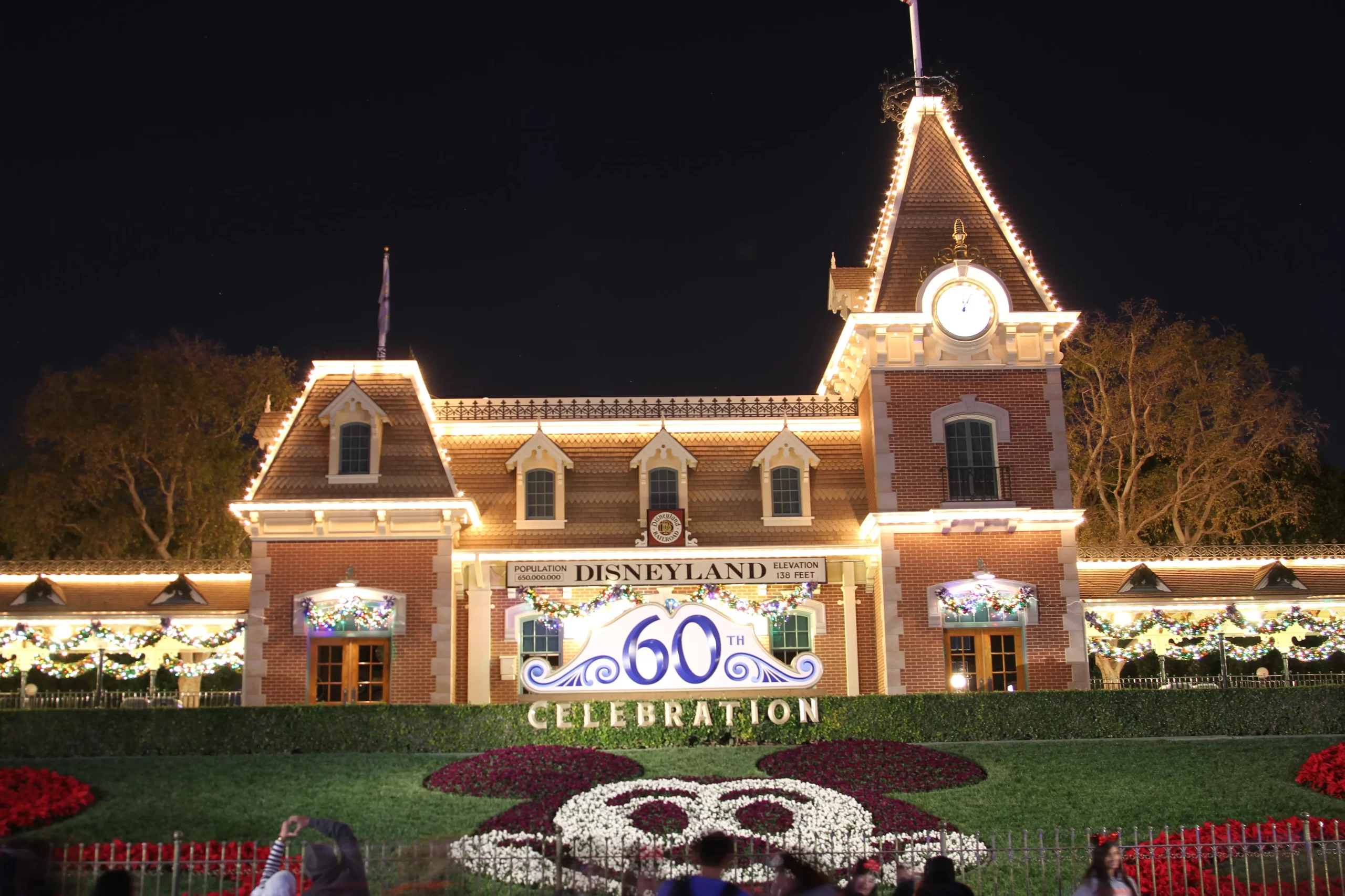 Disneyland entrance clocktower lit up at night